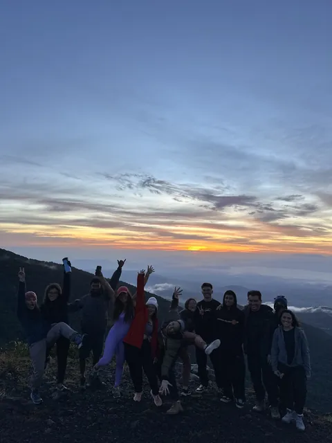 A happy group jumping at sunrise on the Izalco volcano, El Salvador