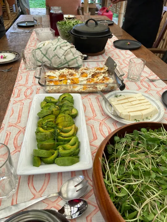 Organic brunch table with avocado, fresh greens and homemade bread