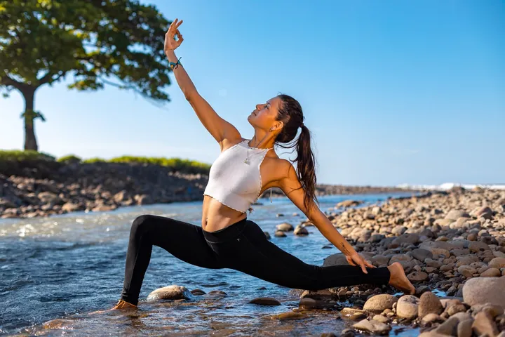 Woman practicing yoga by the sea in Mizata, El Salvador